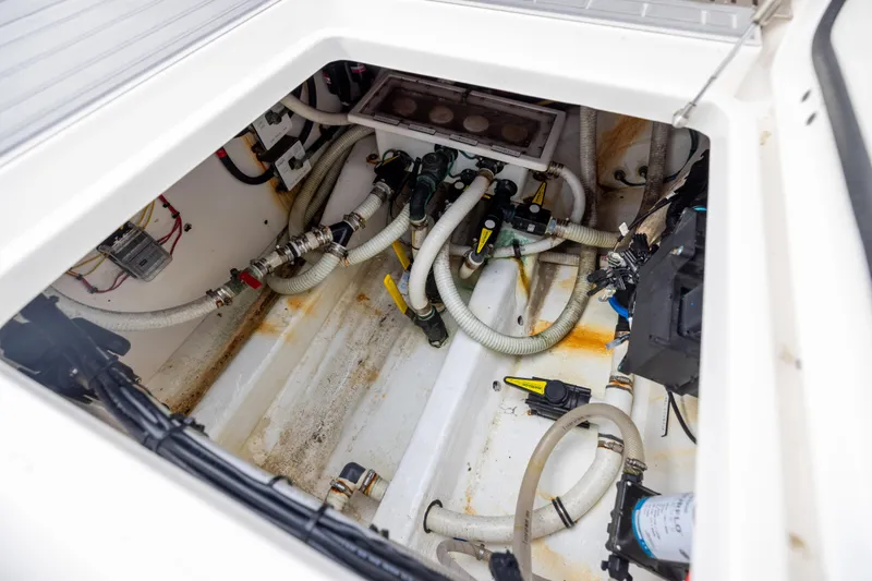Slide: The Image of Engine compartment of a 2020 Invincible 40 Catamaran, showcasing hoses and mechanical components. - 36