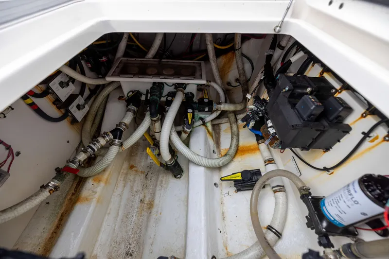 Slide: The Image of Engine compartment of a 2020 Invincible 40 Catamaran, showcasing hoses and electrical components. - 37