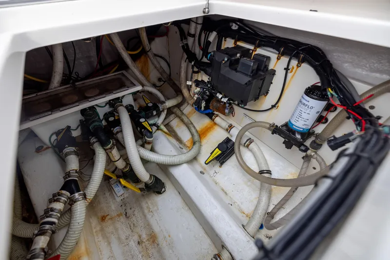 Slide: The Image of Engine compartment of 2020 Invincible 40 Catamaran with hoses and mechanical components. - 38