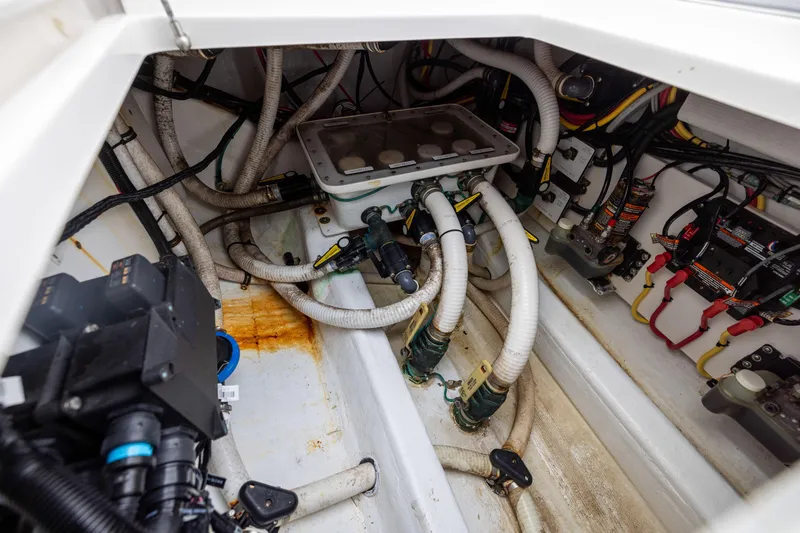 Slide: The Image of Engine compartment of 2020 Invincible 40 Catamaran with hoses and wiring. - 40
