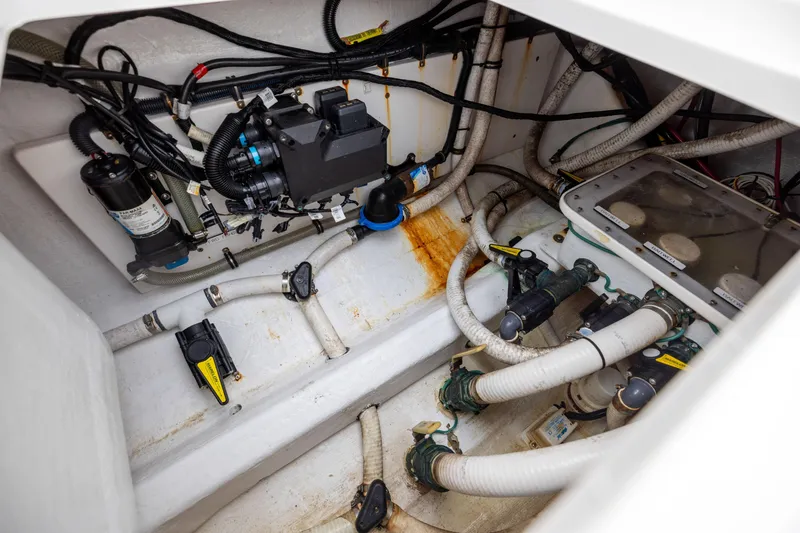 Slide: The Image of Engine compartment of 2020 Invincible 40 Catamaran with visible wiring and plumbing. - 41