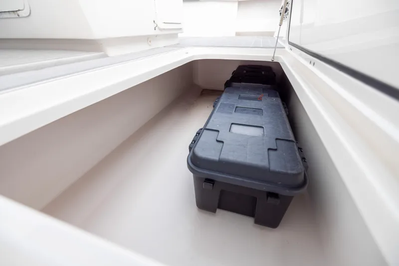 Slide: The Image of Storage compartment on a 2020 Invincible 40 Catamaran with a black storage box inside. - 42
