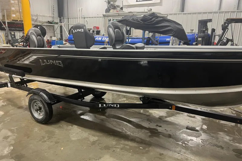 Slide: The Image of 2026 Lund 1600 Fury Tiller boat on trailer in indoor setting. - 5