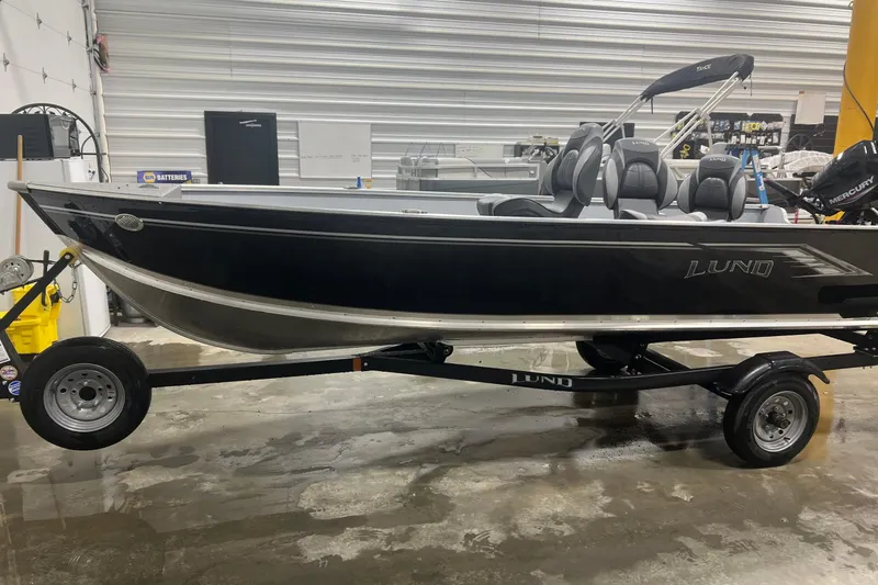 Slide: The Image of 2026 Lund 1600 Fury Tiller boat on trailer in indoor showroom. - 6