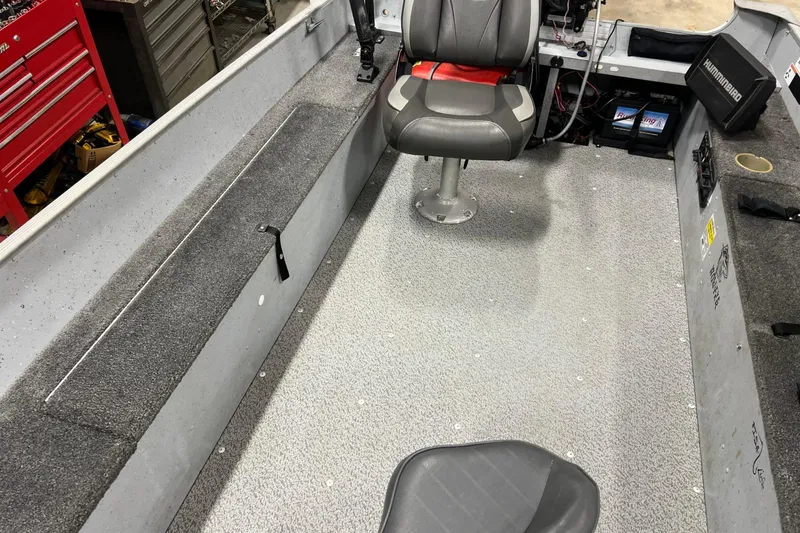 Slide: The Image of 2019 Lund 1600 Fury Tiller boat interior with seating and storage compartments. - 3