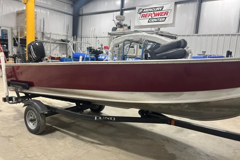 Slide: The Image of 2019 Lund 1600 Fury Tiller boat on trailer in a workshop. - 4
