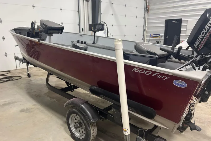 Slide: The Image of 2019 Lund 1600 Fury Tiller boat in garage, maroon color, on trailer. - 6