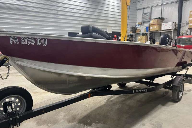 Slide: The Image of 2019 Lund 1600 Fury Tiller boat on trailer in a garage setting. - 7
