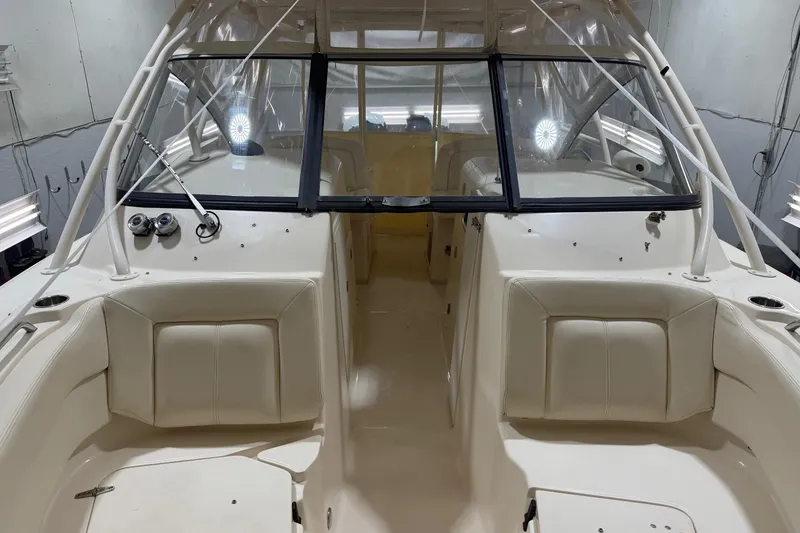 Slide: The Image of 2015 Grady-White Freedom 307 boat interior with beige seating and windshield. - 1
