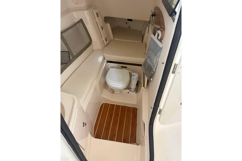 Slide: The Image of 2015 Grady-White Freedom 307 boat interior with toilet and seating area. - 12
