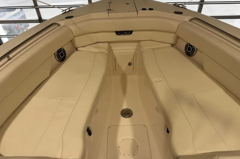 Slide: The Image of 2015 Grady-White Freedom 307 boat interior with beige seating and speakers. - 2