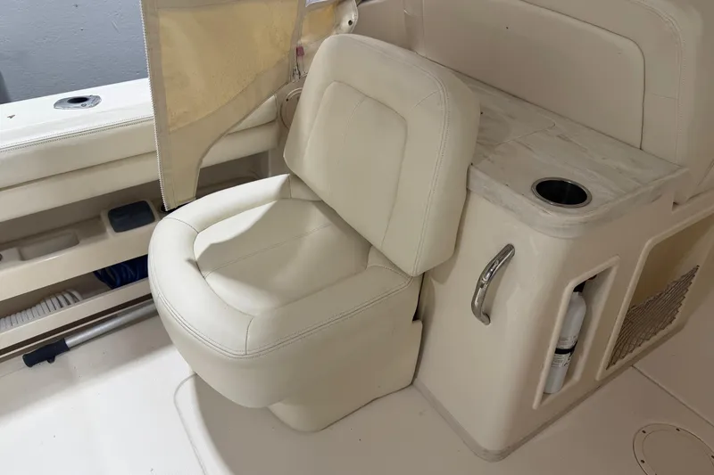 Slide: The Image of 2015 Grady-White Freedom 307 boat interior with beige seating and storage compartment. - 6