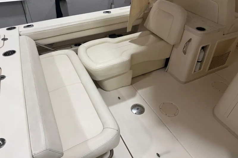 Slide: The Image of 2015 Grady-White Freedom 307 boat interior with beige seating and storage compartments. - 7