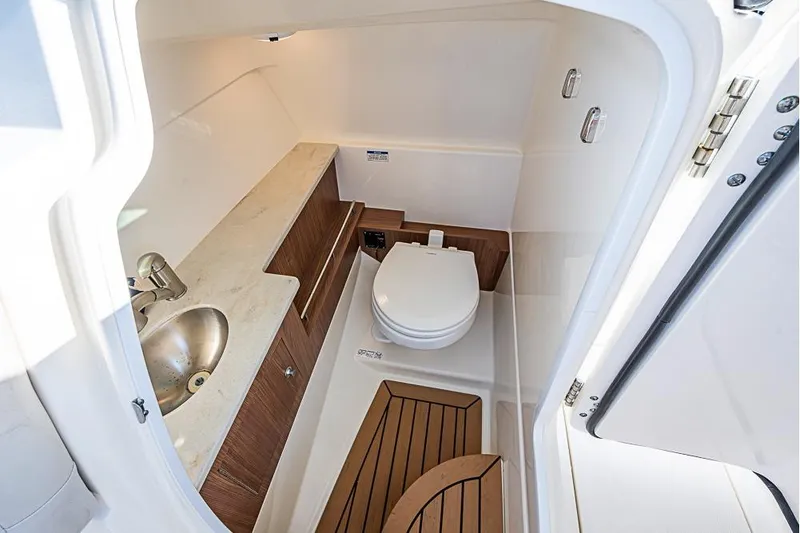 Slide: The Image of 2019 Boston Whaler 270 Vantage boat interior with compact bathroom amenities. - 14