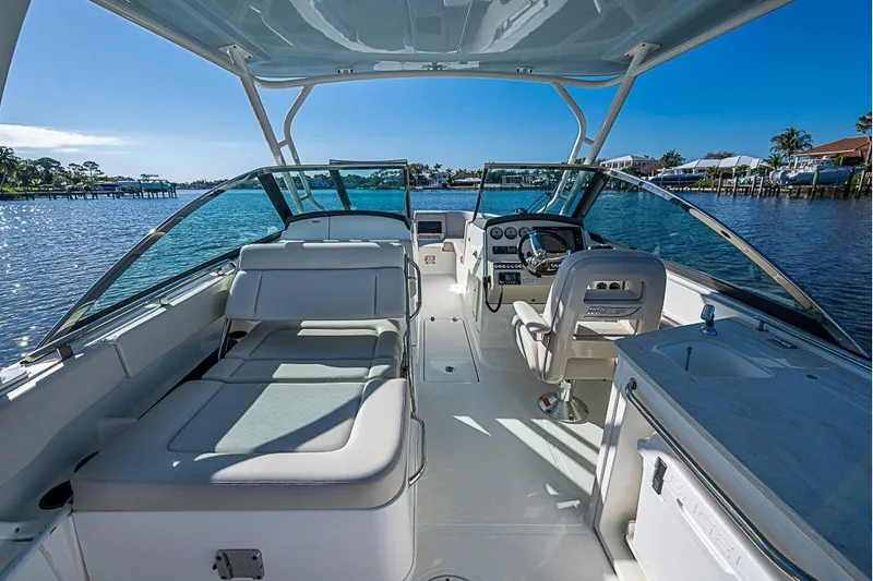 Slide: The Image of 2019 Boston Whaler 270 Vantage boat interior with seating and helm, on a sunny day. - 16