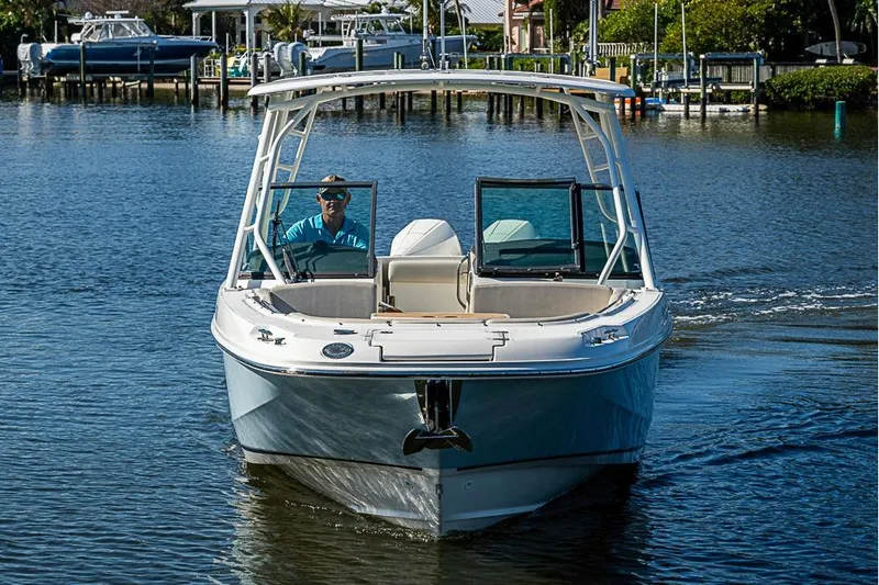 Slide: The Image of 2019 Boston Whaler 270 Vantage boat cruising on a calm waterway. - 2