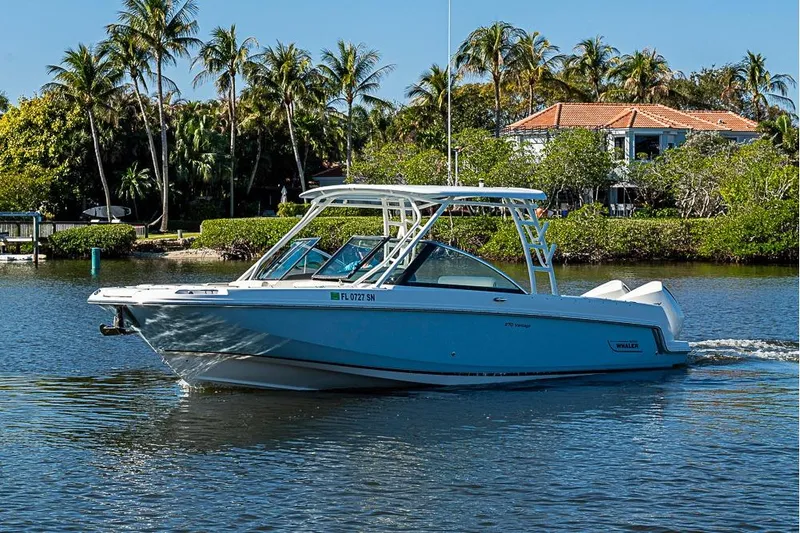 Slide: The Image of 2019 Boston Whaler 270 Vantage boat cruising on a scenic waterway with palm trees. - 22