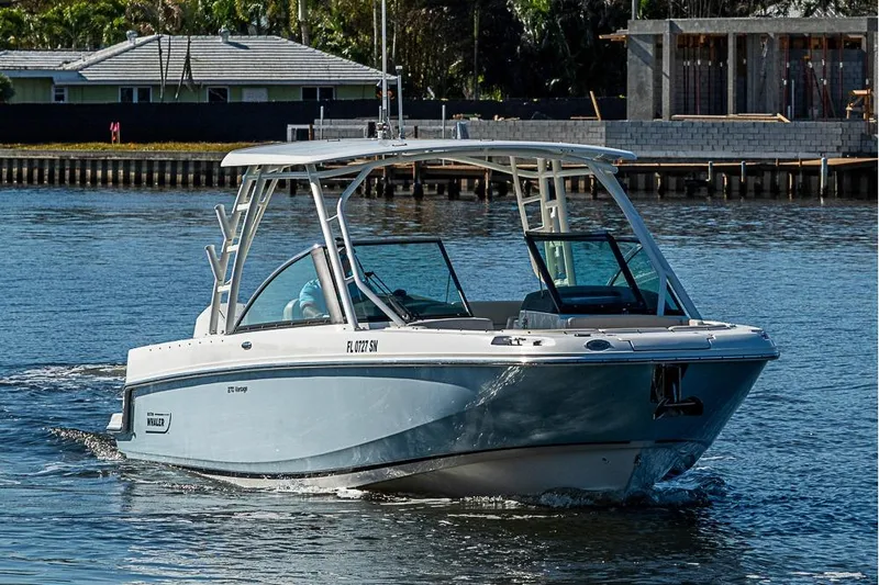 Slide: The Image of 2019 Boston Whaler 270 Vantage boat cruising on a calm waterway. - 23