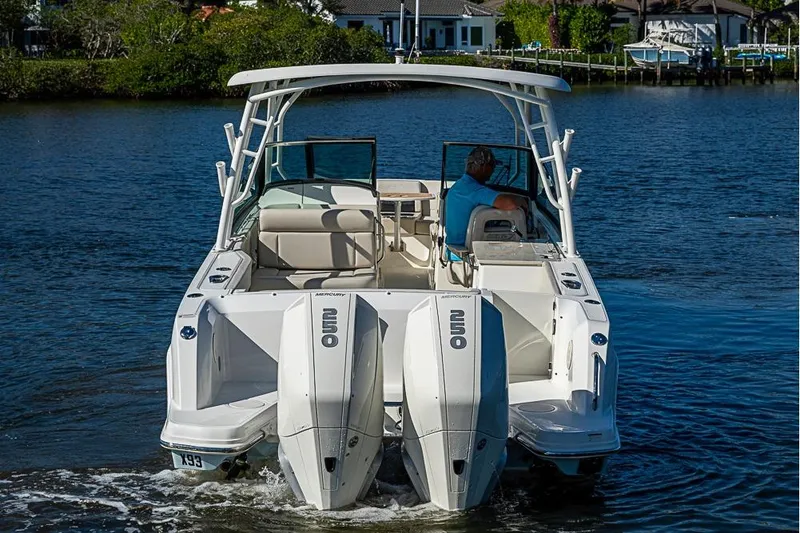 Slide: The Image of 2019 Boston Whaler 270 Vantage boat with dual Mercury engines on a calm waterway. - 3