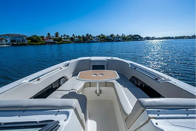 Slide: The Image of 2019 Boston Whaler 270 Vantage boat on serene water with sunny skies. - 6