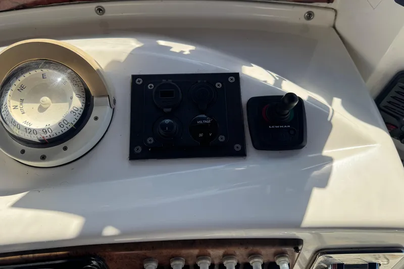 Slide: The Image of 2005 Silverton 43 Motor Yacht dashboard with compass and control panel. - 14