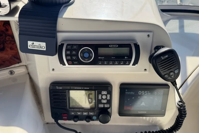 Slide: The Image of Control panel of a 2005 Silverton 43 Motor Yacht with radio and navigation equipment. - 16