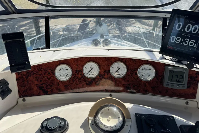 Slide: The Image of 2005 Silverton 43 Motor Yacht dashboard with gauges and navigation equipment. - 17