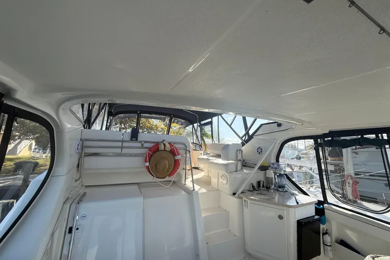 Slide: The Image of 2005 Silverton 43 Motor Yacht interior with seating, life preserver, and outdoor view. - 19