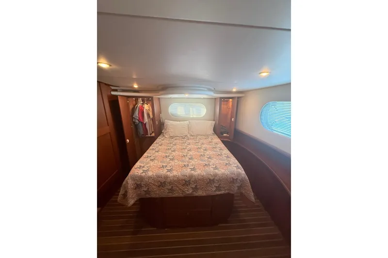Slide: The Image of Interior of 2005 Silverton 43 Motor Yacht bedroom with bed and closet. - 24