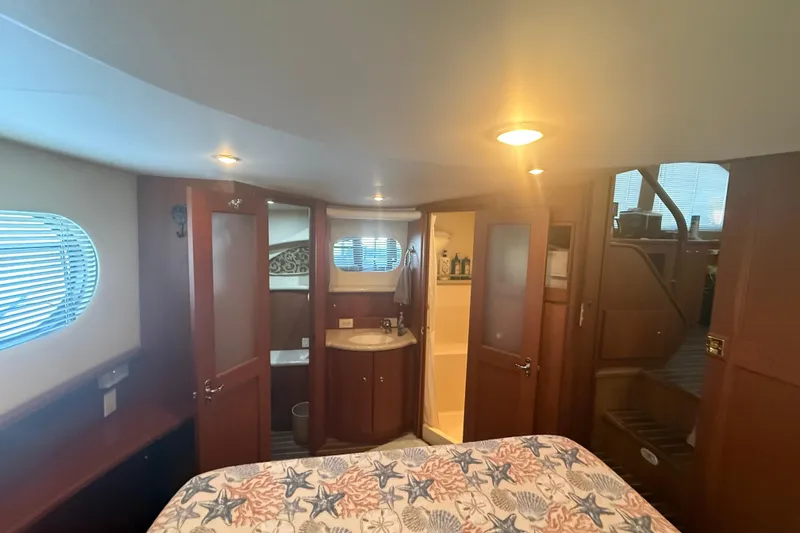 Slide: The Image of Luxurious interior of 2005 Silverton 43 Motor Yacht with cozy bedroom and ensuite bathroom. - 25