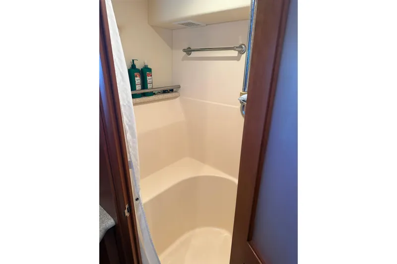 Slide: The Image of Shower area in 2005 Silverton 43 Motor Yacht with toiletries and towel rack. - 27