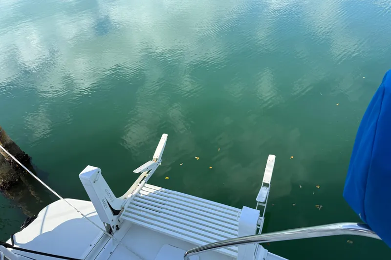 Slide: The Image of 2005 Silverton 43 Motor Yacht swim platform with ladder over calm water. - 28