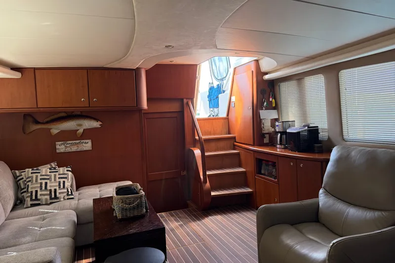 Slide: The Image of Luxurious interior of 2005 Silverton 43 Motor Yacht with cozy seating and wooden accents. - 3