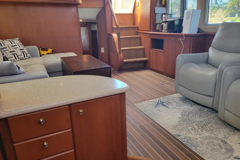 Slide: The Image of Interior of 2005 Silverton 43 Motor Yacht with cozy seating and wooden cabinetry. - 31