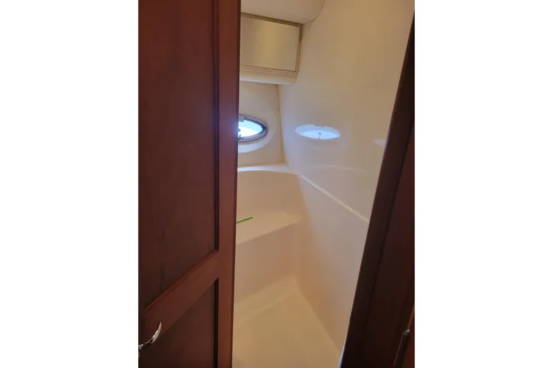 Slide: The Image of Interior view of 2005 Silverton 43 Motor Yacht bathroom with porthole window. - 33