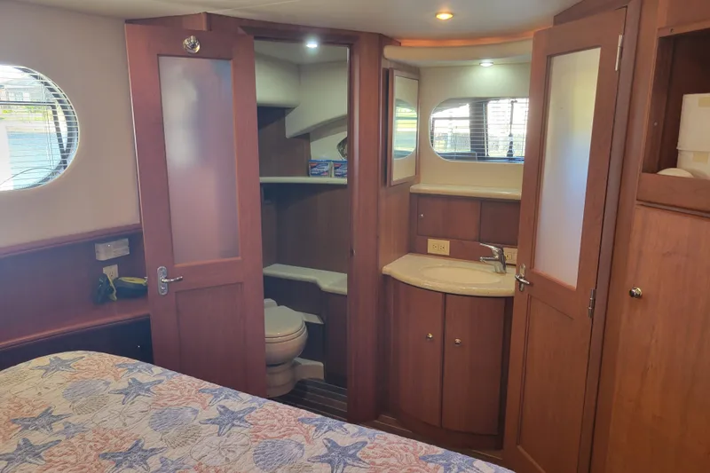 Slide: The Image of Luxurious 2005 Silverton 43 Motor Yacht interior with wood finish and ensuite bathroom. - 37