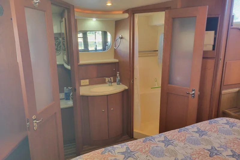 Slide: The Image of Interior of 2005 Silverton 43 Motor Yacht with bathroom and wooden cabinetry. - 38