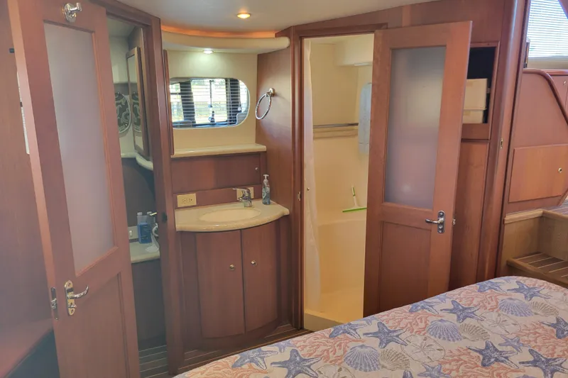 Slide: The Image of Interior of 2005 Silverton 43 Motor Yacht with bathroom and wooden cabinetry. - 39