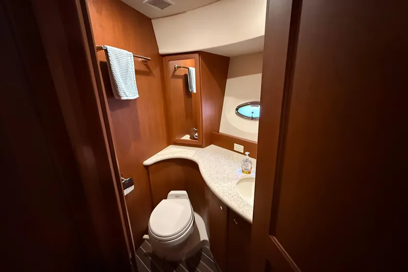 Slide: The Image of Luxurious bathroom in 2005 Silverton 43 Motor Yacht with wood accents and modern fixtures. - 8