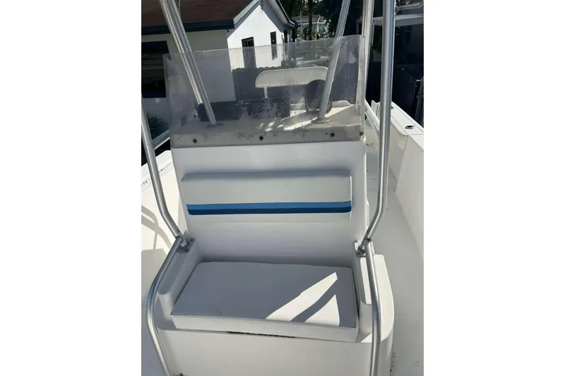 Slide: The Image of 1997 Cobia 244 Center Console boat interior with seating and console view. - 10