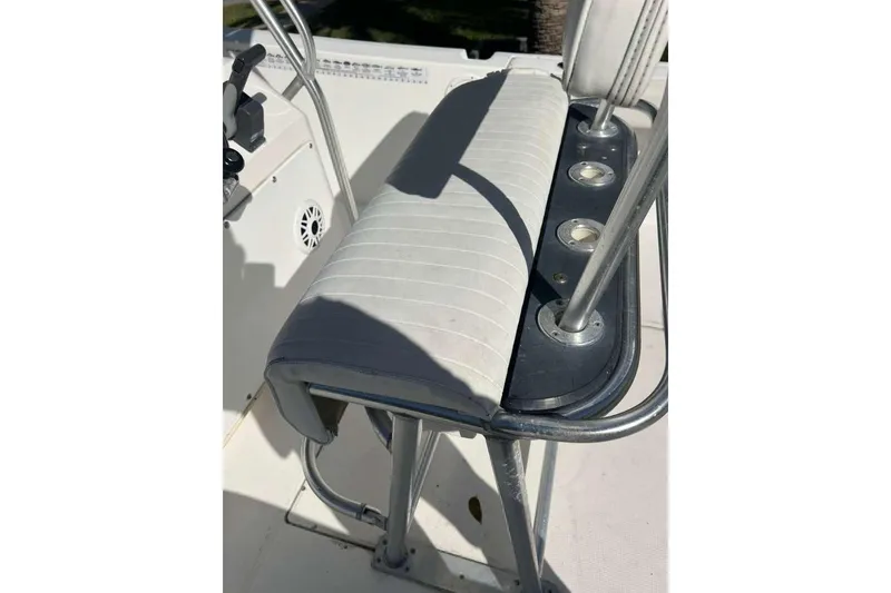 Slide: The Image of 1997 Cobia 244 Center Console boat seat with rod holders and control panel. - 11