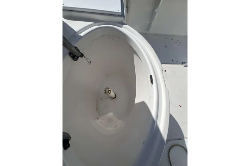 Slide: The Image of 1997 Cobia 244 Center Console boat interior with open storage compartment. - 12
