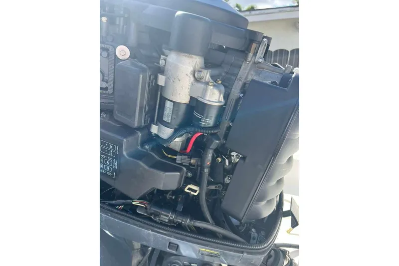 Slide: The Image of 1997 Cobia 244 Center Console boat engine close-up, showcasing mechanical components. - 19