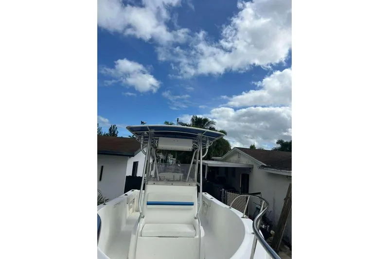 Slide: The Image of 1997 Cobia 244 Center Console boat under a partly cloudy sky. - 6