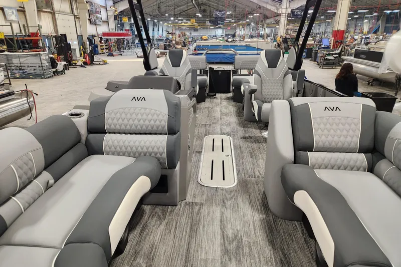 The Image of 2026 Avalon Catalina Quad Lounge Shift boat interior with luxurious seating in a spacious factory setting. - 1