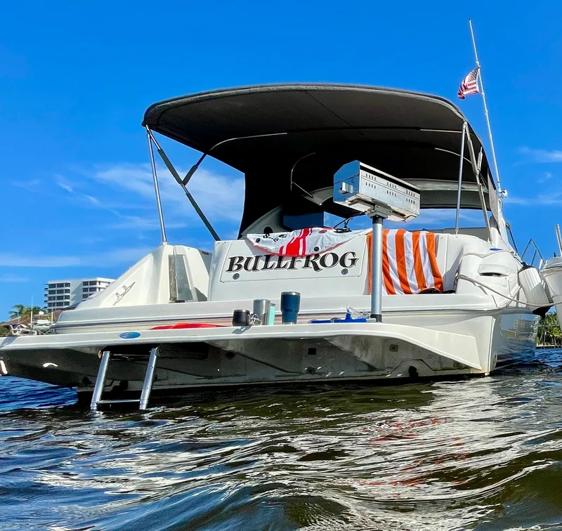 Slide: The Image of 1995 Sea Ray Sundancer 370 boat on the water. - 1