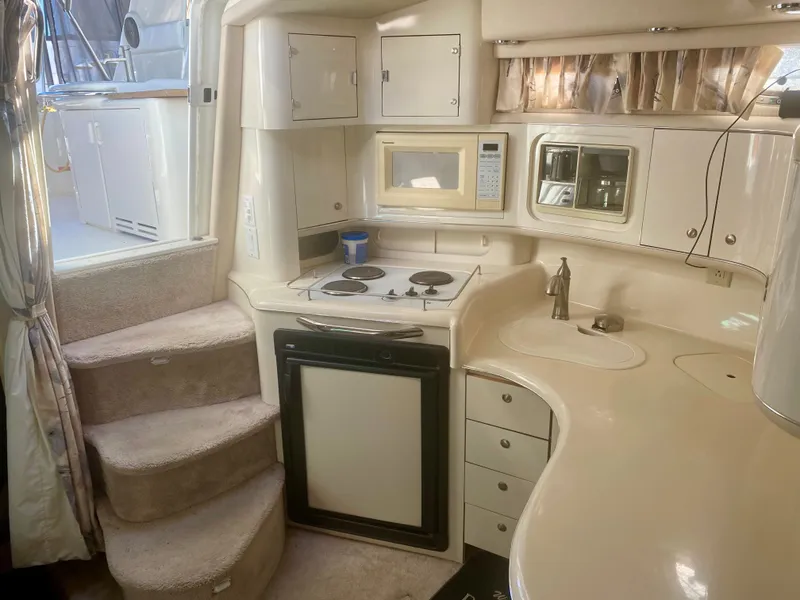Slide: The Image of Interior of 1995 Sea Ray Sundancer 370 yacht with kitchen and stairs. - 7