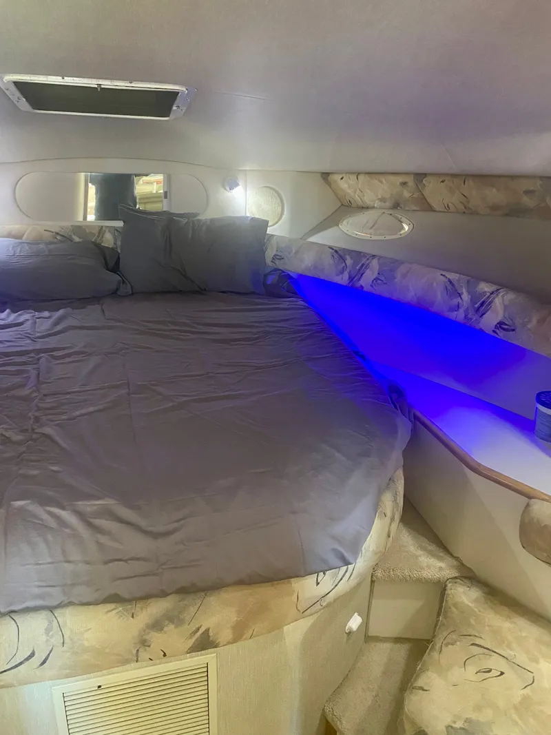 Slide: The Image of Interior of Sea Ray Sundancer 370 yacht, cozy bed with blue lighting. - 8