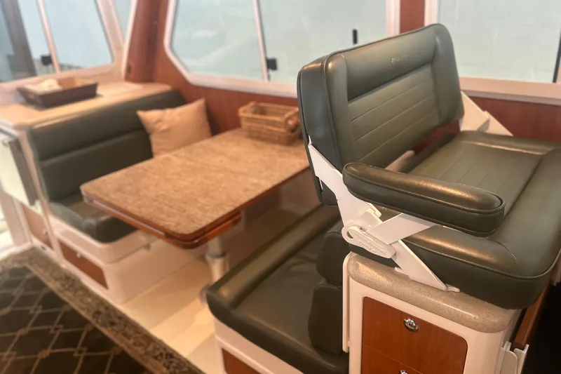 Slide: The Image of Interior of 2007 True North 38 Heritage yacht with leather seating and dining table. - 11