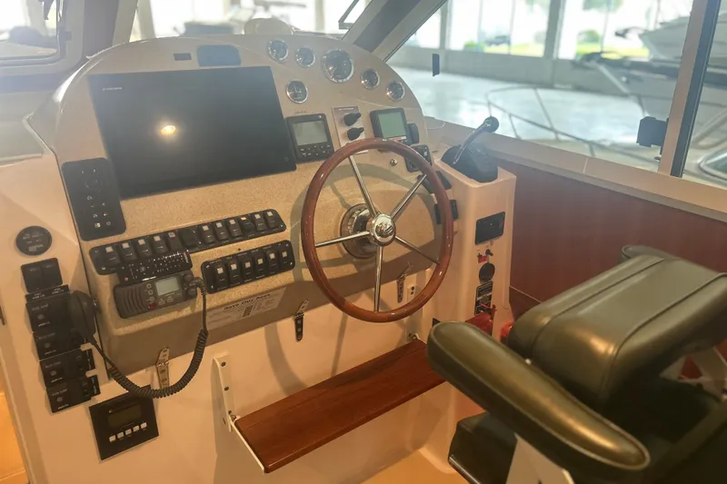 Slide: The Image of Helm of 2007 True North 38 Heritage boat with steering wheel and navigation controls. - 16